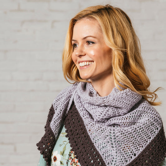 Blonde woman wearing Evangelina, a pale gray and purple lace shawl in Andorra