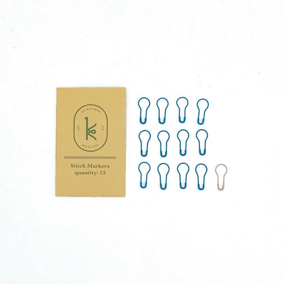 Kelbourne Woolens stitch markers and gold envelope packaging on a white background.